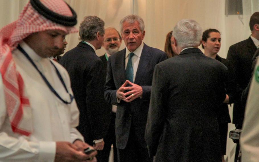 Defense Secretary Chuck Hagel mingles with delegates before his speech at the Manama Dialogue, an annual security conference in Bahrain, Dec. 7, 2013.