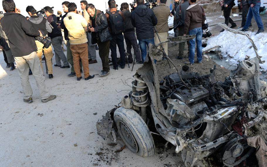 The remains of a car at the scene of a suicide bombing in Kabul Monday that killed at least two foreign contractors working for the NATO-led International Security Assistance force. 
