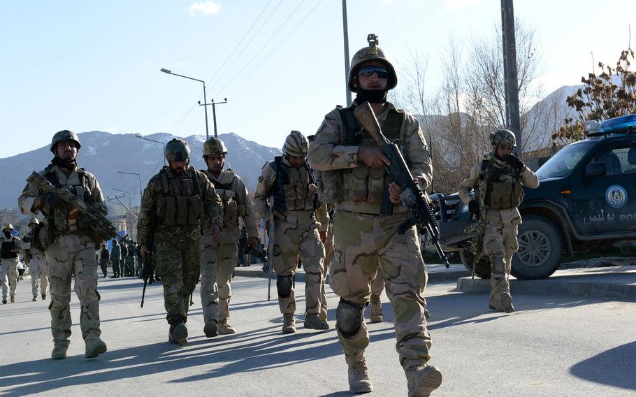 In this file photo from March 2014, Afghan national security forces leave the scene of an attack on an election office in Kabul.