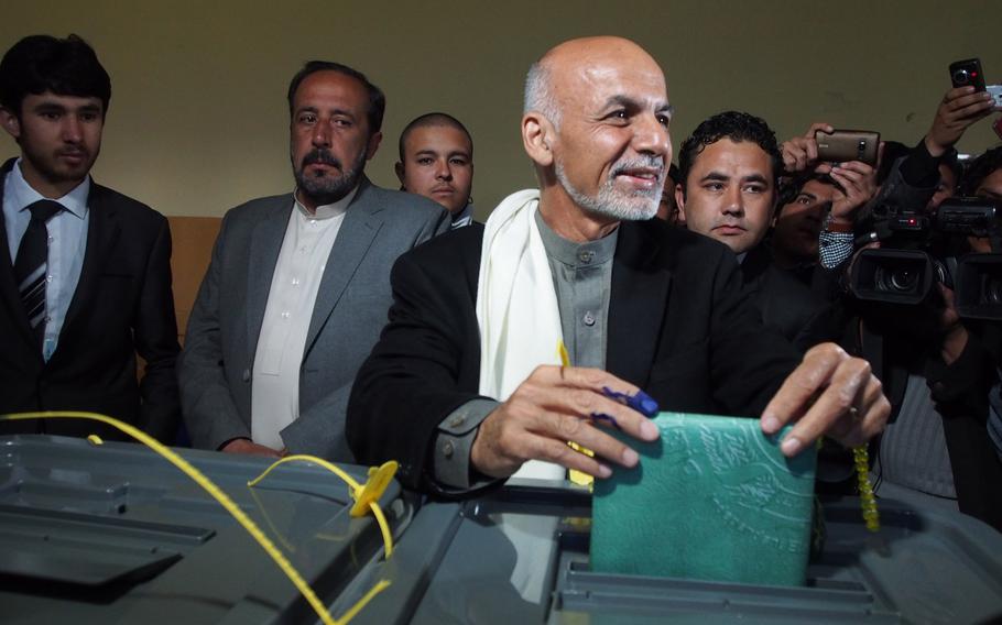 Afghan presidential hopeful Ashraf Ghani casts his vote in Kabul on Saturday, April 5, 2014, the day millions of Afghans went to the polls to elect a new president. A successful election would mark the first democratic transfer of authority in the country's history. 