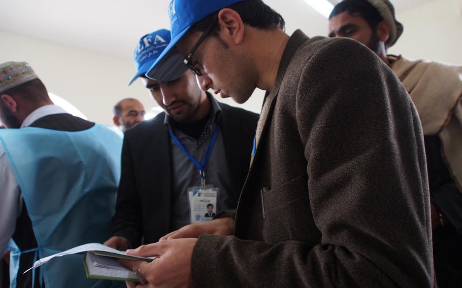 Staffers with the Free and Fair Election Foundation of Afghanistan search for their observers at a polling station in Pul-e Charki, an area on the outskirts of Kabul that saw massive fraud in the 2009 presidential elections. FEFA, Afghanistan's leading domestic election observer group, was monitoring the presidential election Saturday, April 5, 2014.