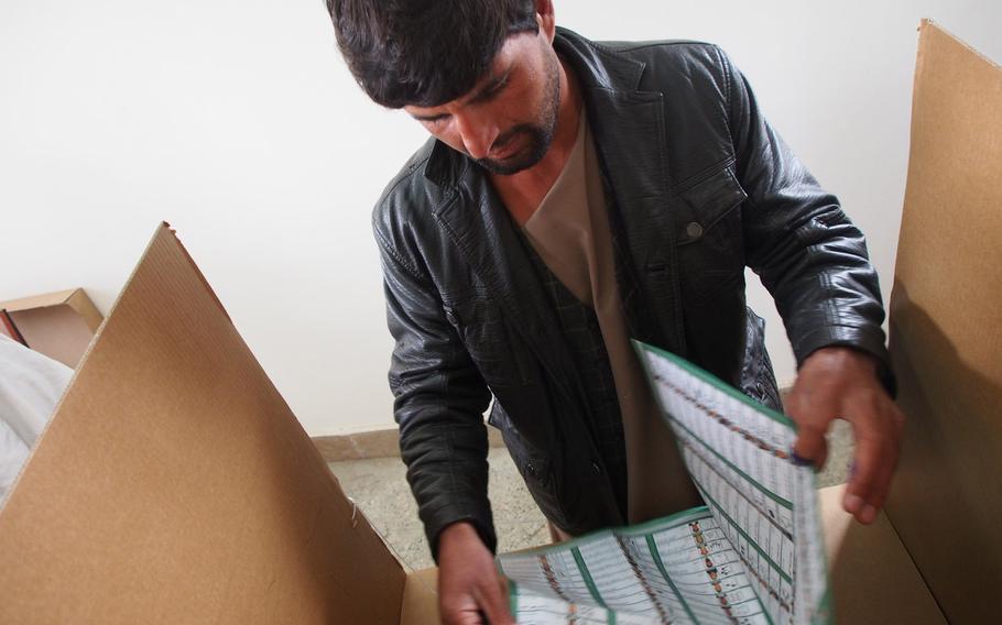 A voter opens his ballot in Kabul on Saturday, April 5, 2014, during Afghanistan's presidential election. The vote is seen as crucial to both the stability of the country and the legacy of the more than 12-year-old U.S.-led military effort there. 