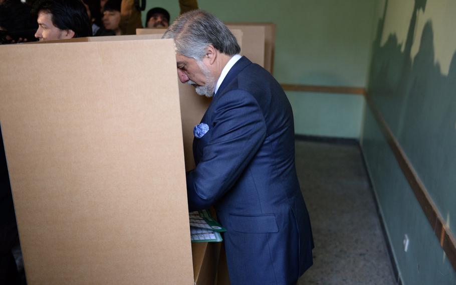 Afghan presidential candidate Abdullah Abdullah casts his vote at a high school in central Kabul on Saturday, April 5, 2014.