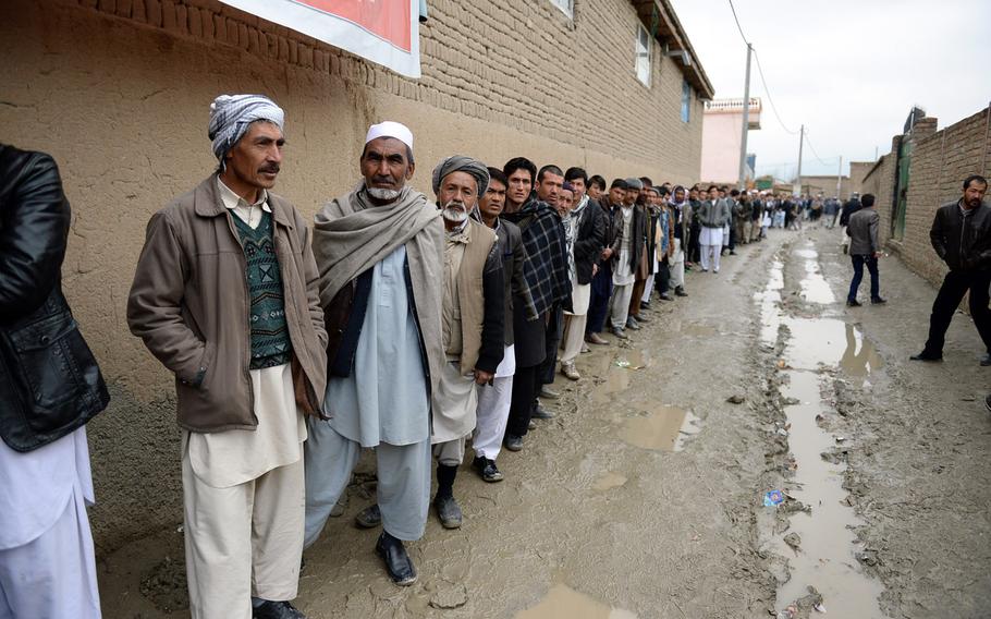 Afghan men lined up for more than an hour in this neighborhood in western Kabul, waiting to vote in the national elections on Saturday, April 5, 2014.