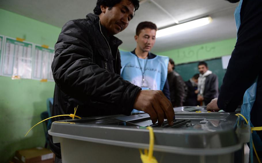 Kabul resident Mohammed Sherzai casts his vote at a school in western Kabul on Saturday, April 5, 2014. The national elections drew long lines of Afghans in Kabul, but turnout in rural areas was more uncertain.