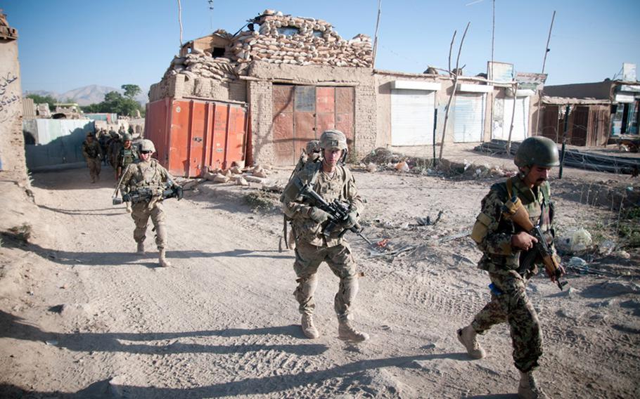 In this file photo taken June 27, 2012, Sgt. Colton Hurley, an infantry team leader with the 82nd Airborne Division's 1st Brigade Combat Team, leaves Combat Outpost Muqor on patrol, in Ghazni province, Afghanistan.