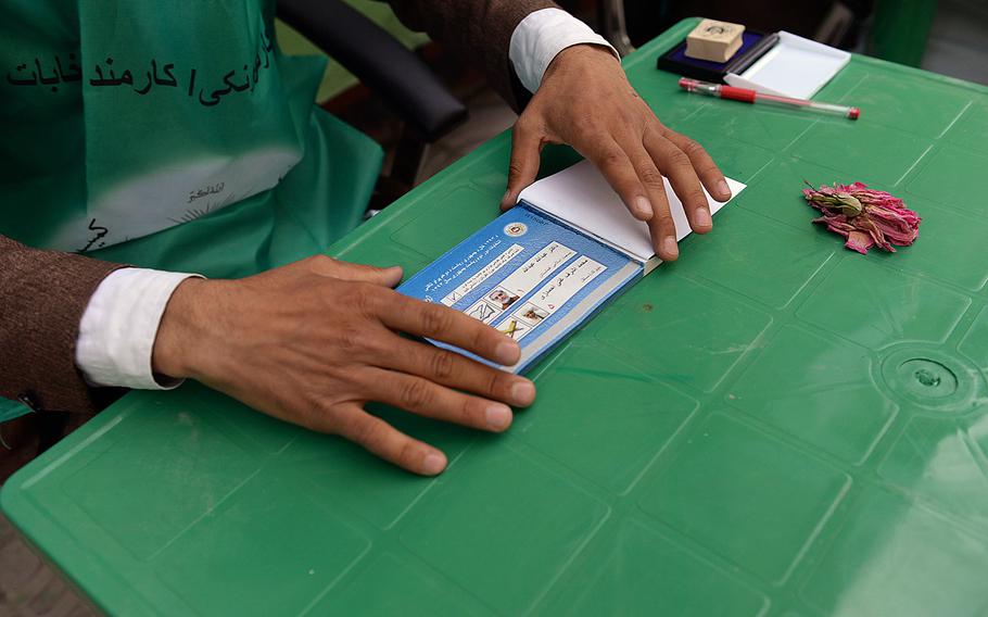 An election worker prepares ballots with the names of Afghanistan's final presidential contenders at a polling station in Wardak province. Fraud remained a major worry, especially at rural locations.

