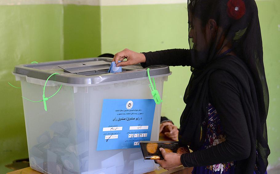 An Afghan woman casts her vote at a polling station in Kabul during a runoff election between Afghanistan's top two presidential candidates. Turnout appeared to be lower than during the first round when some 7 million people voted.
