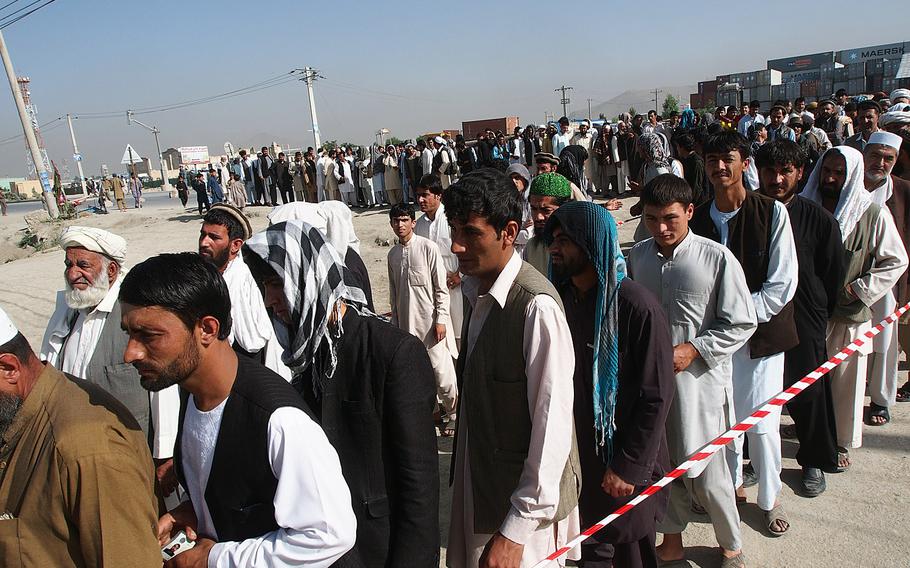 Afghans line up to vote for president in Kabul Saturday. Lines like this were rare in the city, a contrast to the first round of the elections in April, when voters waited for hours in the rain to cast their ballots. 
