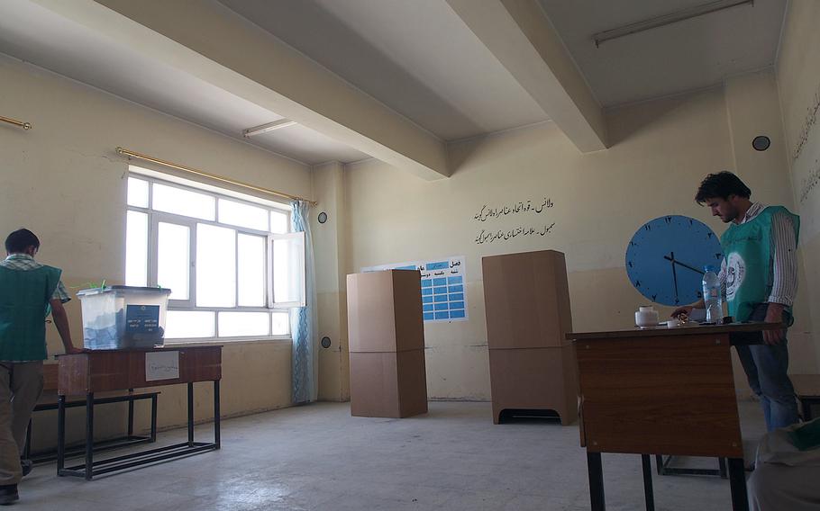 Election workers wait for voters at an empty polling station in Kabul Saturday, during the final round of voting in Afghanistan's presidential election. There seemed to be less enthusiasm for the second round of the election, as compared to the initial vote in April, and voters blamed fear of violence and corruption. 