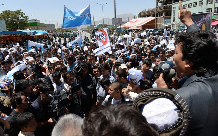 A crowd supportive of Afghan presidential candidate Abdullah Abdullah shouts slogans accusing the government of committing fraud in the June 14 presidential election runoff on Saturday, June 21, 2014, in Kabul. Abdullah, who is running against former Finance Minister Ashraf Ghani, claims the election was rigged.
