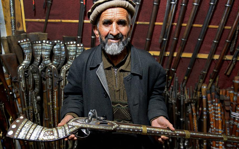 Sher Mohammed holds a replica jezail musket in his shop in downtown Kabul Jezails, which were originally handmade by Afghans during their fight against the British in the 19th century, have survived along with other antique guns as a popular souvenirs for American servicemembers.
