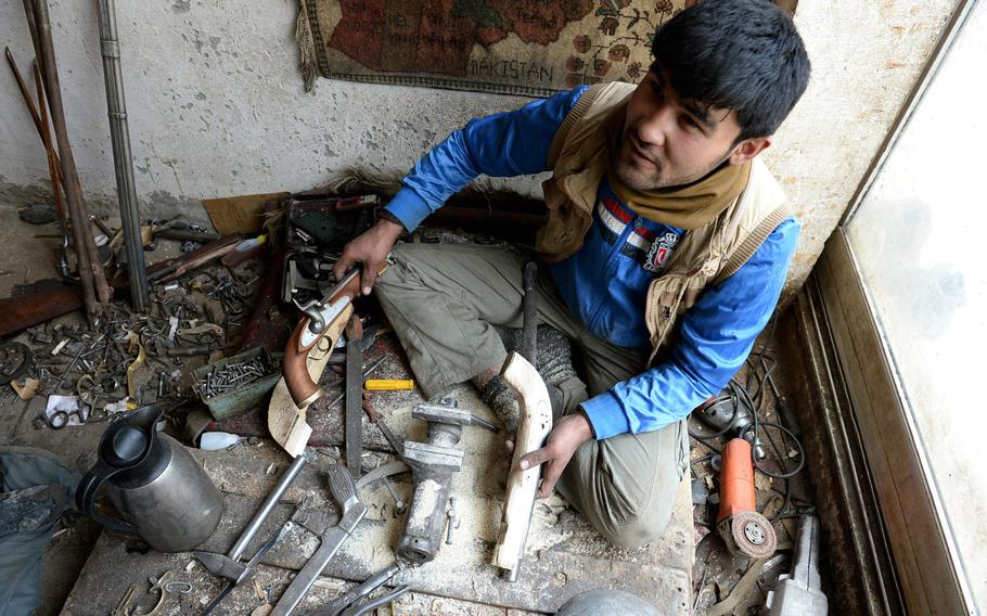 Nisar Ahmad, 22, shows examples of a finished replica pistol and one he is still working on in his workshop in Kabul. The tradition of making firearms by hand in Afghanistan dates to before the fight against British armies in the 19th century.


