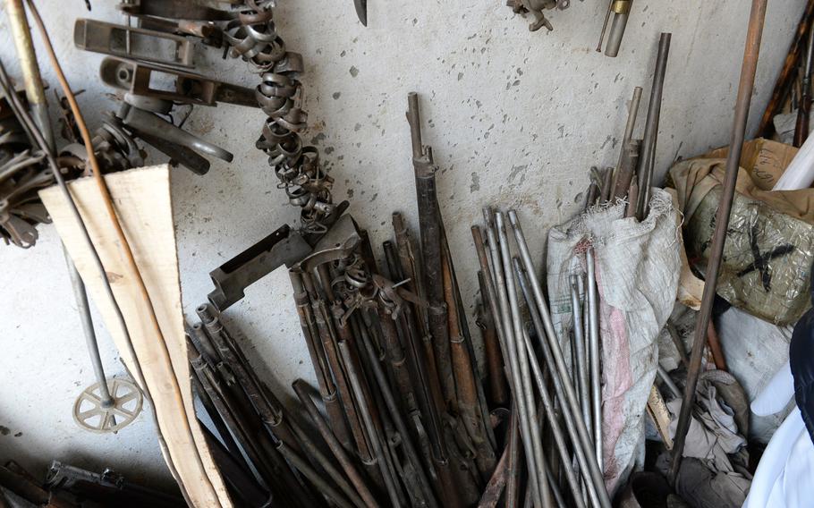 Old pieces of guns, pipes, and other scrap metal line the wall in a workshop in Kabul where craftsmen use the material to cobble together handcrafted replicas of early Afghan weapons like the jezail.

