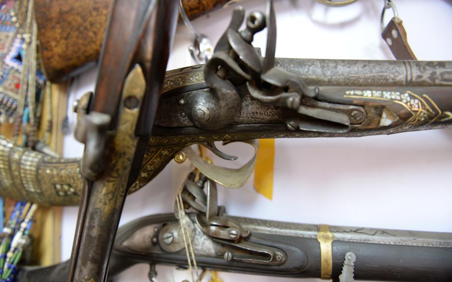 Several jezail muskets hang in a shop on NATO’s Bagram Air Field in Afghanistan. The shop’s Afghan owner, Mohammed, says sales of such antique and replica weapons have dwindled as troops depart.