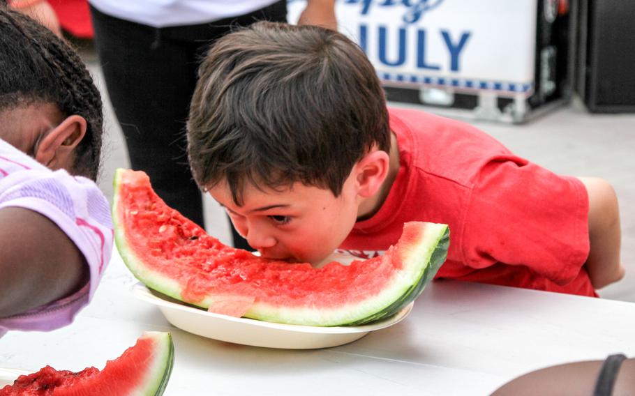 Jericho Darnell eats on to win the children's watermelon eating contest at the ''Freedom Rocks'' celebration, put on by Morale, Welfare and Recreation at Naval Support Activity Bahrain, on July 3, 2014.
