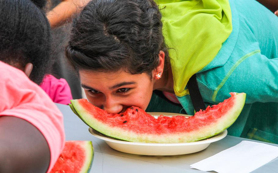 Josie Rojas participates in a watermelon eating contest at the ''Freedom Rocks'' celebration, put on by Morale, Welfare and Recreation at Naval Support Activity Bahrain, on July 3, 2014.