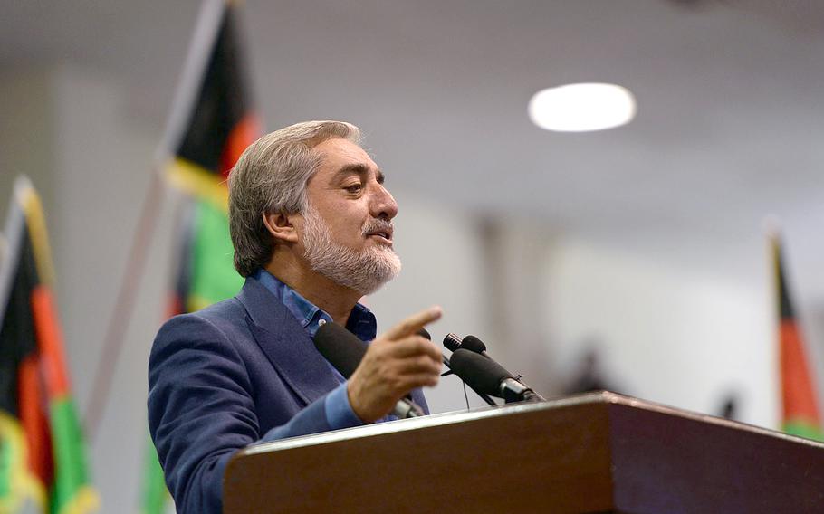 Afghan presidential candidate Abdullah Abdullah speaks to supporters at a meeting in Kabul, the day after officials released preliminary election results. He told the crowd he would sacrifice himself before accepting fraudulent results.