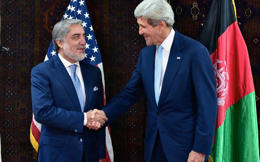 U.S. Secretary of State John Kerry shakes hands with Afghan presidential candidate Abdullah Abdullah at the U.S. Embassy in Kabul on Friday, July 11, 2014.