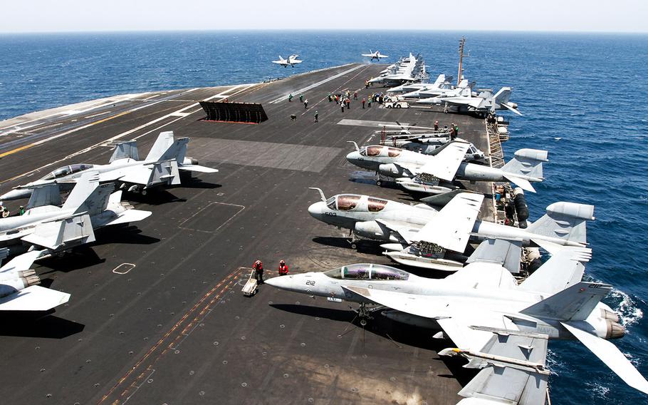 Two F/A-18 Hornet strike fighters launch simultaneously from the deck the USS George H.W. Bush, underway in the the Persian Gulf, Aug. 11, 2014.