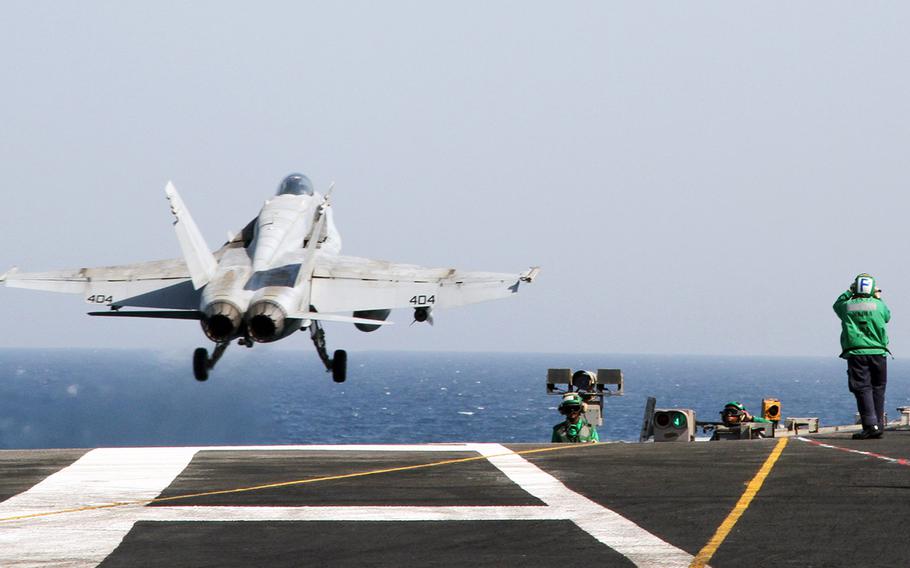 An F/A-18 Hornet launches from the flight deck of the USS George H.W. Bush while underway in the Persian Gulf on Aug. 11, 2014.
