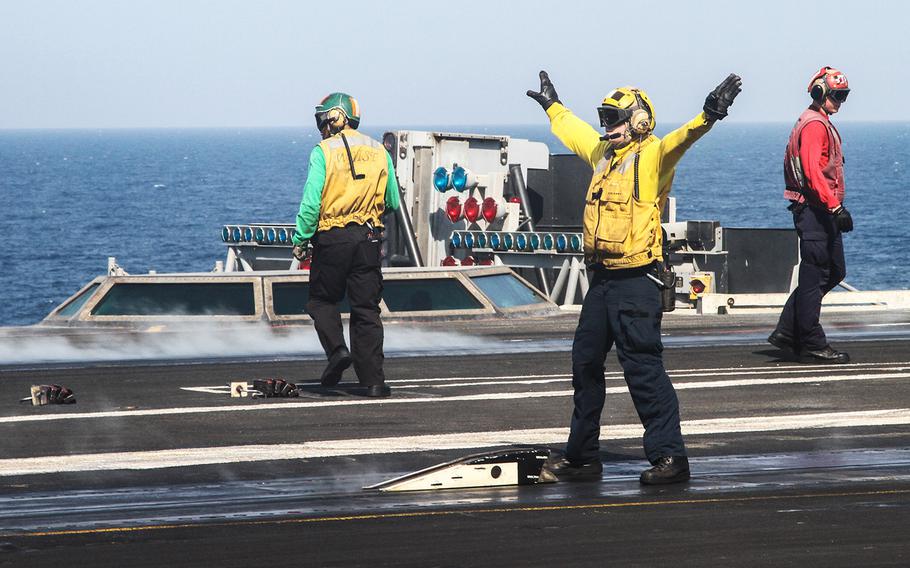 Flight deck crews on the USS George H.W. Bush, underway in the Persian Gulf, prepare for the first morning launch of aircraft in support of an ongoing mission to suppress Islamic State militants in Iraq.