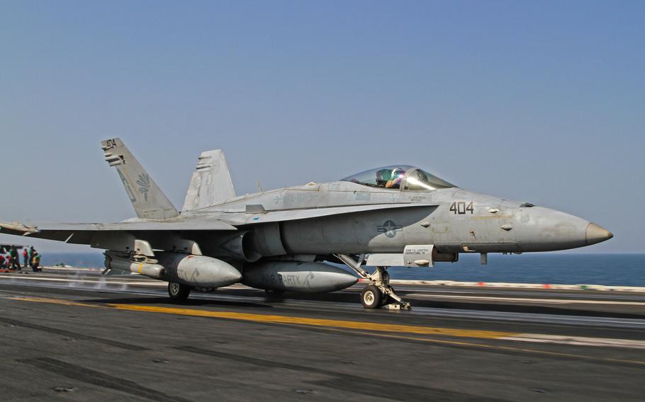 An F/A-18 roars across the flight deck as it launches off the USS George H.W. Bush, underway in the Persian Gulf, Aug 10, 2014. Super Hornets are among the aircraft launched from the Bush that are conducting airstrikes in Iraq.
