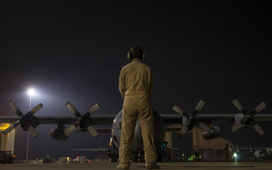 Master Sgt. Pennie J. Brawley assists pilots during a pre-flight inspection prior to a humanitarian airdrop over Iraq on Aug. 13, 2014, at a base in the U.S. Central Command area of responsibility.