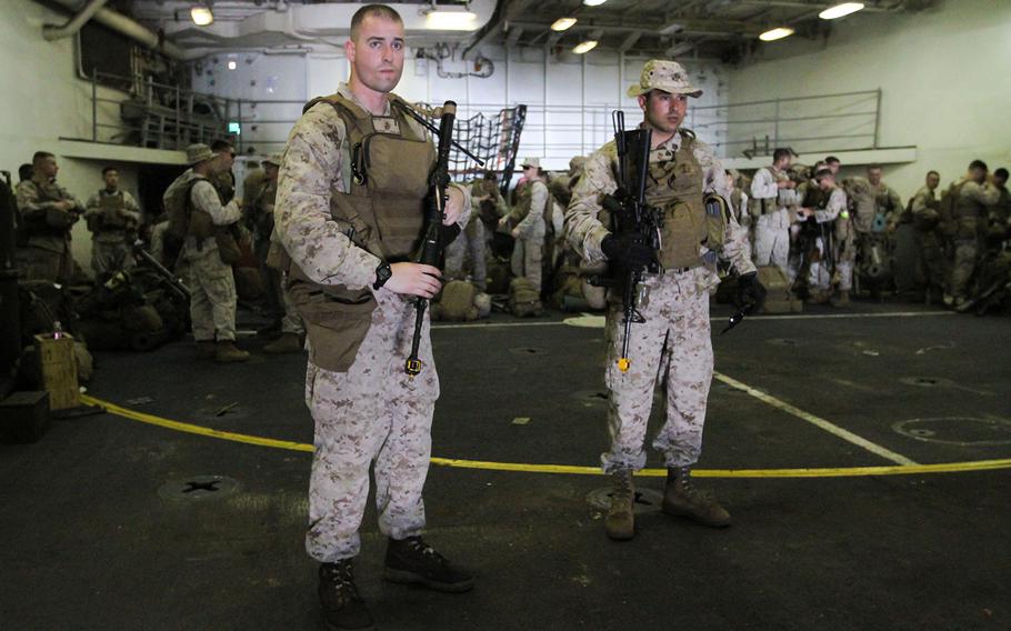 U.S. Marines from the 22nd Marine Expeditionary Unit embarked on the dock landing ship USS Gunston Hall prepare to board a landing craft to transport them ashore in Djibouti for an exercise, April 15, 2014.