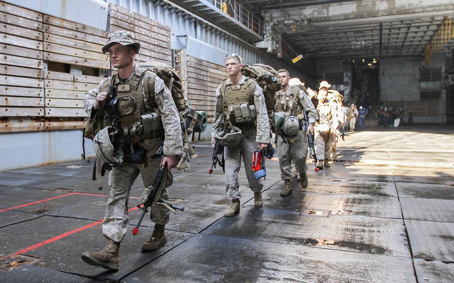 U.S. Marines from the 22nd Marine Expeditionary Unit embarked on the dock landing ship USS Gunston Hall walk across the well deck to board a landing craft to transport them ashore in Djibouti for an exercise, April 15, 2014.