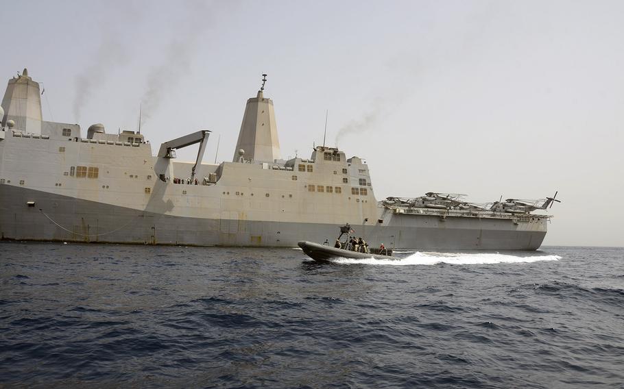 Sailors aboard a Naval Special Warfare rigid-hull inflatable boat practice coming alongside the amphibious transport dock ship USS Mesa Verde during routine small boat training. 