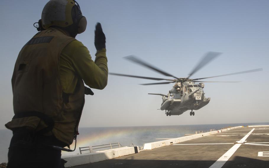 A sailor guides a U.S. Marine Corps CH-53E Super Stallion helicopter landing aboard the amphibious transport dock ship USS  Mesa Verde during routine flight operations in the U.S. 5th Fleet area of responsibility, July 11, 2014.
 
Manuel A. Estrada/U.S. Navy