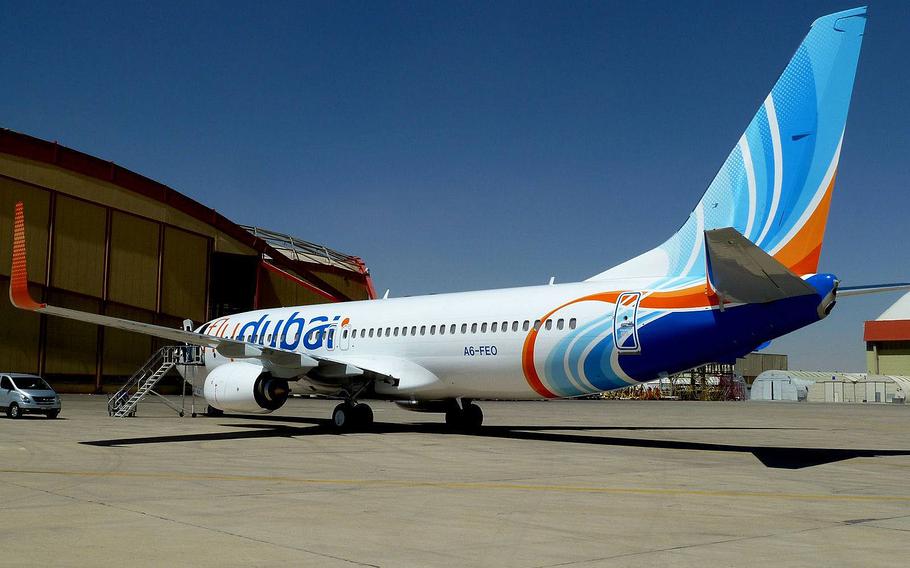 A flydubai aircraft sits parked on the tarmac of an undisclosed airfield.