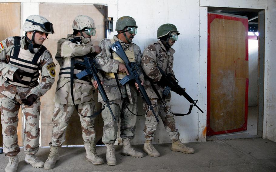 A squad of Iraqi soldiers clears a building during an exercise at the Besmaya Training Center on Dec. 17, 2009. Housed at a former Republican Guard complex, the center included 26 weapons ranges, M1A1 tank training and a bomb disposal school.
