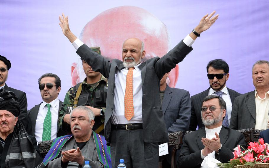 Afghan presidential candidate Ashraf Ghani waves to the crowd at a campaign rally in Kabul. Afghanistan’s new government on Tuesday signed a long-delayed security deal with the United States that sets out the terms to allow nearly 10,000 U.S. troops to remain past the December deadline for the withdrawal of coalition combat troops.
