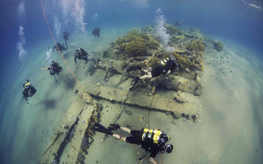 Clearance divers from Fleet Diving Unit 3 assigned to Task Group 523.3, along with divers from the Royal Naval Force of Jordan, conduct a search dive as part of the International Mine Countermeasures Exercise (IMCMEX) on Oct. 29, 2014. IMCMEX includes navies from 44 countries. 