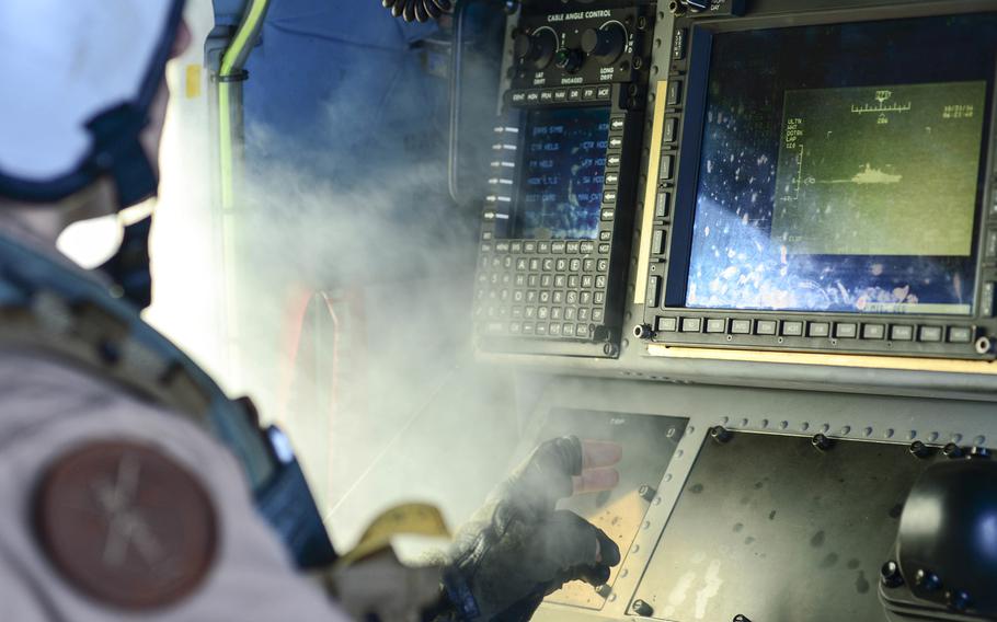 Naval Aircrewman 2nd Class Arron Hall operates the surveillance control station of an MH-60R Seahawk helicopter from the Battle Cats of Maritime Strike Squadron (HSM) 73 during the International Mine Countermeasure Exercise, IMCMEX on Oct. 31, 2014. IMCMEX is a joint mine countermeasure exercise involving 44 navies.