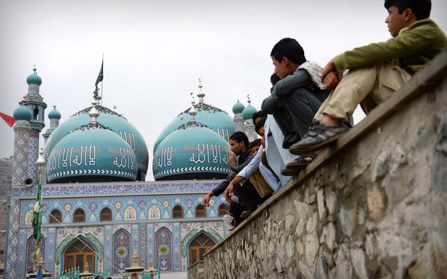 Afghan men sit outside a mosque in Kabul after a Ashoura event on Nov. 3, 2014. Security forces shut down streets around the city to prevent a repeat of the attack that killed 63 people at such a gathering in 2011.