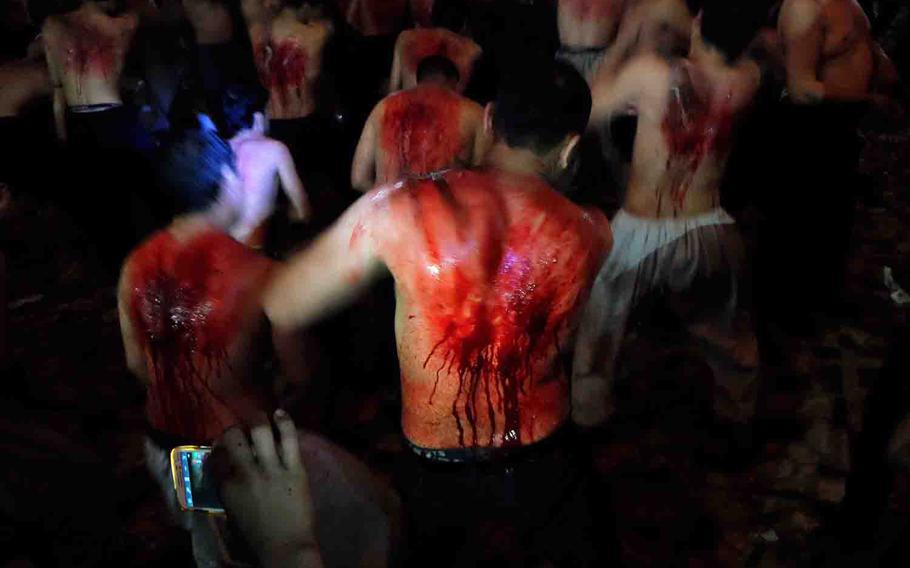 Afghan Shi'ite Muslim men flagellate themselves at a Muharram ceremony on the Day of Ashoura in Kabul on Nov. 3, 2014. The practice of drawing blood with chains or knives is viewed as a way to show mourning for the death of Husayn ibn Ali's in an ancient battle.