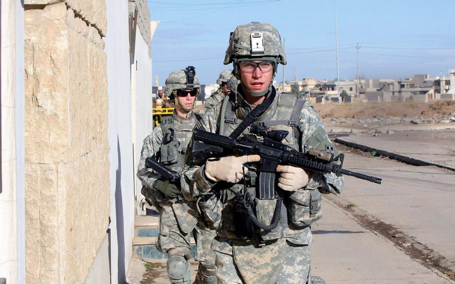 Soldiers from Red Platoon, Company A, 1st Battalion, 8th Infantry Regiment patrol the streets of Mosul, in northern Iraq, in February 2008.
