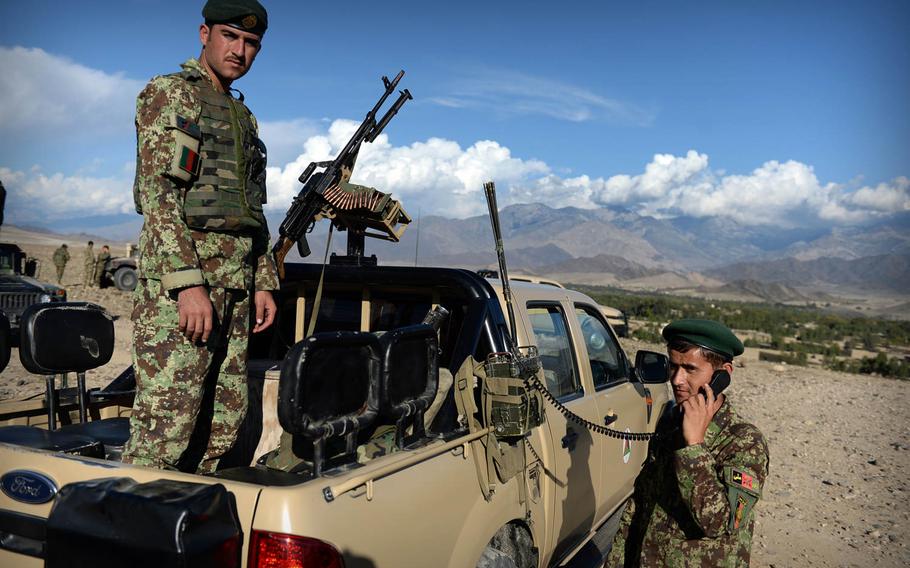 Afghan National Army soldiers help coordinate artillery fire during a joint clearing operation with police in Laghman province Nov. 4, 2014. Insurgents were still firing as troops packed up their equipment and ended the operation.

