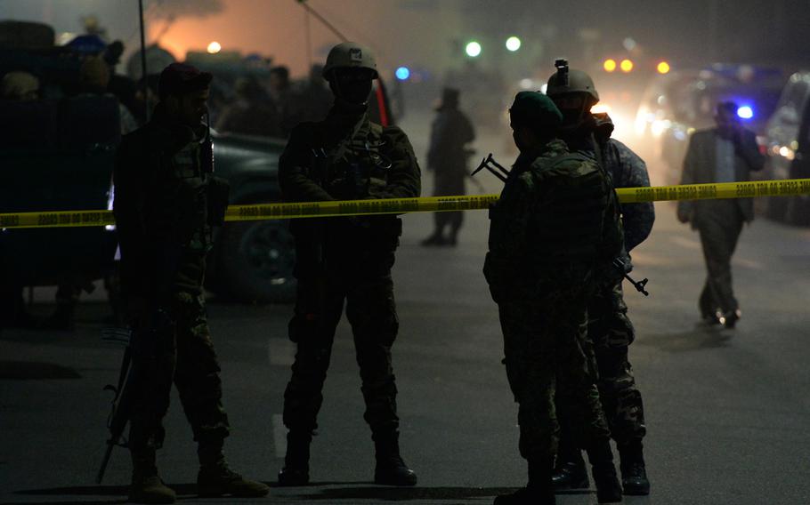 Afghan security forces secure the scene of a bombing at a French-run cultural center and school in Kabul on Dec. 11, 2014.

