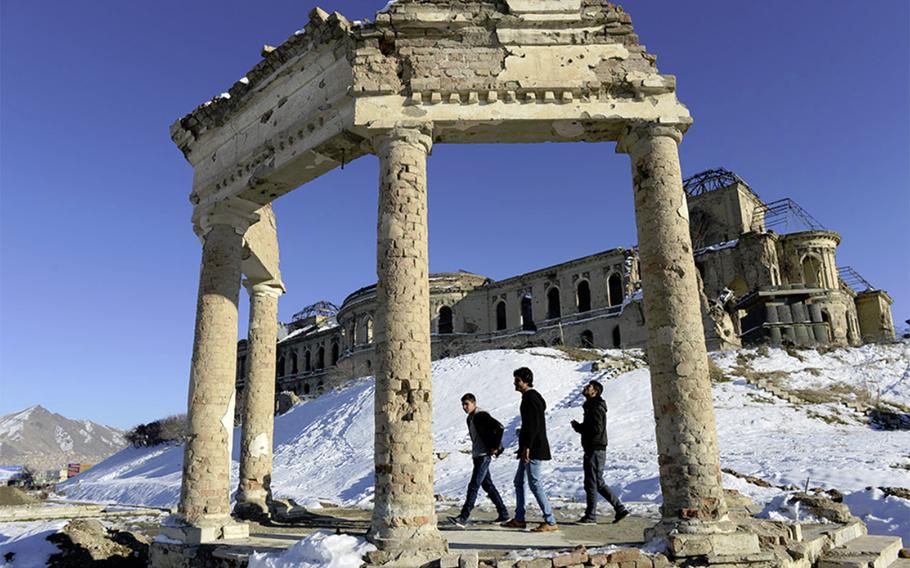 Young men walk the grounds of Darulaman Palace in west Kabul.