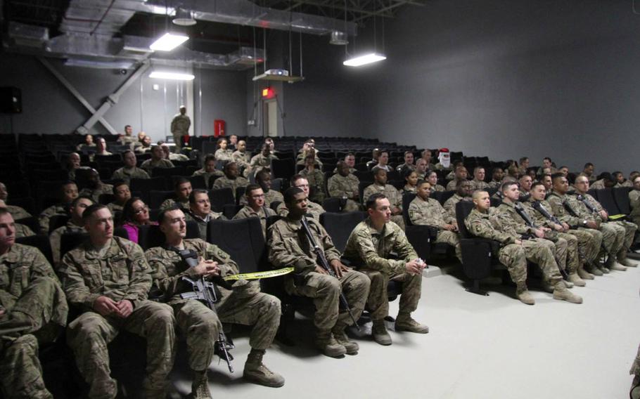 Soldiers gather at Bagram Air Field's MWR Theater in Afghanistan for a holiday celebration Dec. 24, 2014, where they enjoyed photos with Santa, a 'white elephant' gift exchange, food, a sing-off and a viewing of the movie 'National Lampoon's Christmas Vacation.'