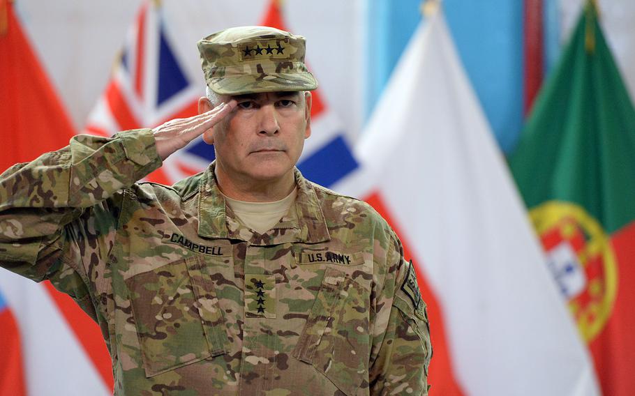 Gen. John Campbell, commander of the U.S.-led International Security Assistance Force (ISAF) in Afghanistan, salutes at a ceremony in Kabul on Sunday, Dec. 28, 2014, marking the change of the military coalition's mission to one more focused on training and advising.
