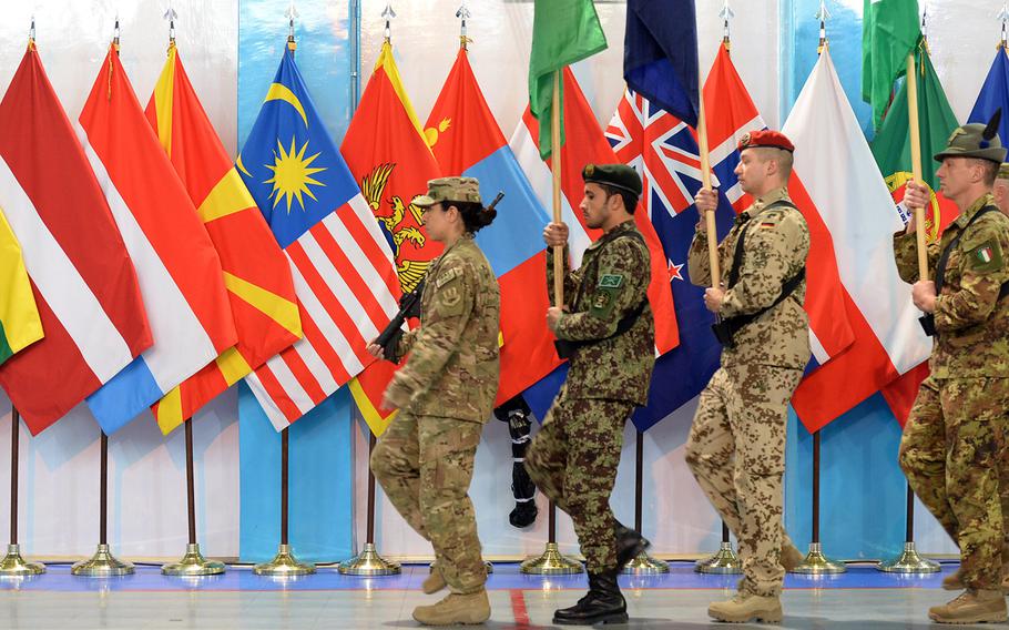 Troops march during a ceremony in Kabul on Sunday, Dec. 28, 2014, marking a change in the 13-year U.S.-led military mission in Afghanistan. The International Security Assistance Force formally ended its mission. The new train and advise mission begins Jan. 1.