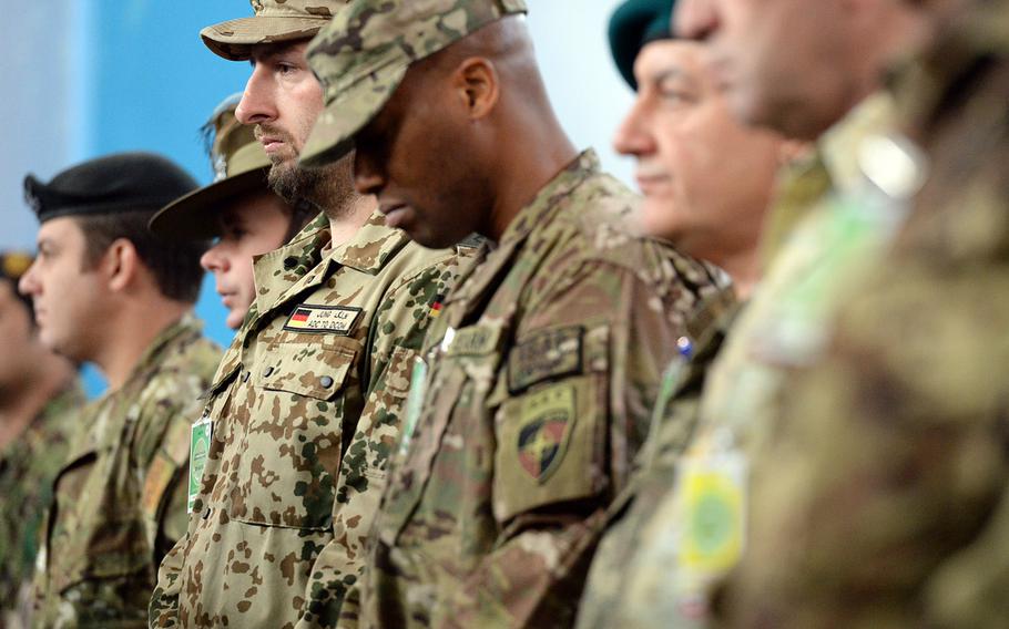 A soldier bows his head during a prayer at a ceremony to mark a scaling down of the U.S.-led military mission in Afghanistan. The ceremony on Sunday, Dec. 28, 2014, marked the end of the International Security Assistance Force.