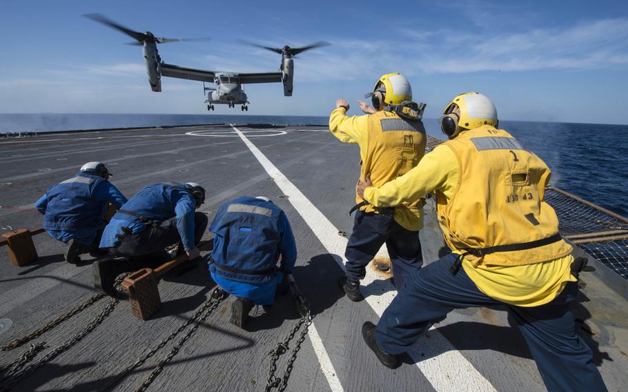 Sailors aboard the amphibious dock landing ship USS Fort McHenry signal an MV-22 Osprey to launch from the flight deck Jan. 11, 2015. Fort McHenry and the USS Iwo Jima have moved  into the Red Sea for a possible evacuation of U.S. Embassy workers from the Yemen capital of Sanaa. 

