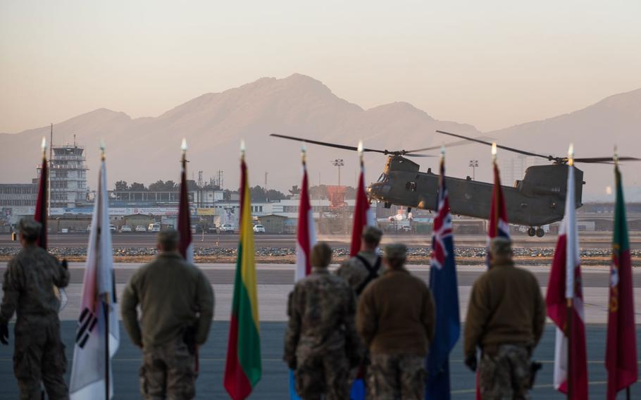 A U.S. Army CH-47 Chinook lands at North Kabul Afghanistan International Airport, Afghanistan. Three contractors working with the international military coalition in Afghanistan were shot and killed Thursday, Jan. 29, 2015, on the military side of the airport. 