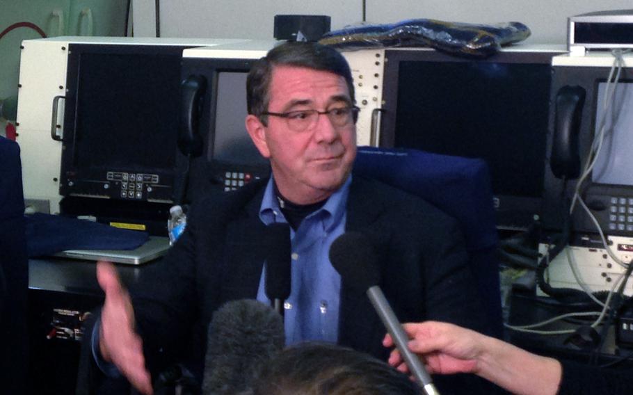 Secretary of Defense Ashton Carter speaks to reporters aboard a U.S. military aircraft en route to Afghanistan.